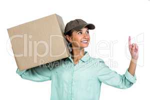Happy delivery woman holding box pointing up