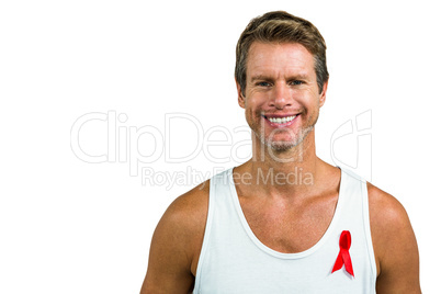 Portrait of man wearing aids ribbon on vest
