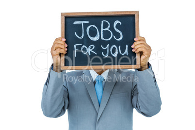 Businessman holding black board