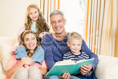 Happy parents reading to their kids