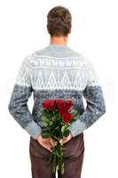 Rear view of man hiding red roses
