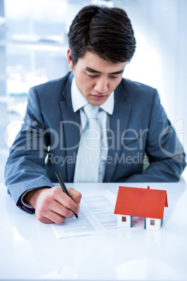 Asian businessman read a estate contract Asian businessman read a estate contract
