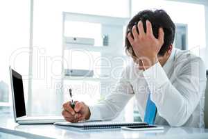 Focused asian businessman writing