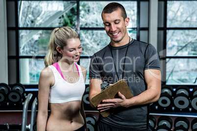 Fit woman discussing performance with trainer