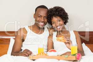 Happy family lying in bed together