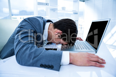 Businessman lying on his desk