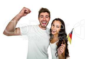 Portrait of smiling couple holding German flag