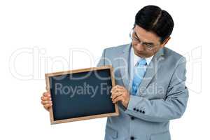Asian businessman holding a black board