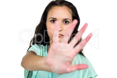 Frowning woman putting hand on camera