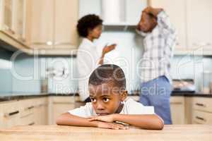 Sad boy against parents arguing