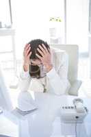 Stressed businesswoman working at her desk