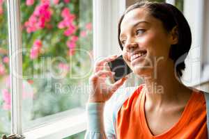 Smiling brunette on a phone call