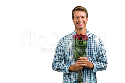 Portrait of smiling man holding bouquet of roses
