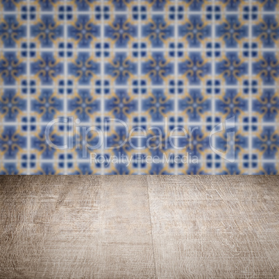 Wood table top and blur vintage ceramic tile pattern wall