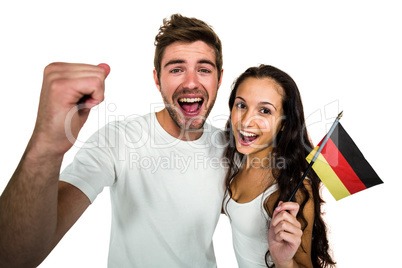 Portrait of excited couple holding German flag