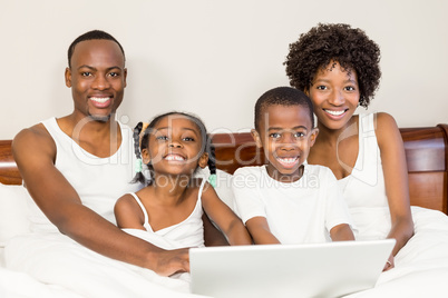 Happy family lying in bed together Happy family lying in bed together