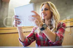 Smiling female student using tablet