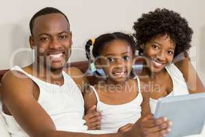 Happy family lying in bed together