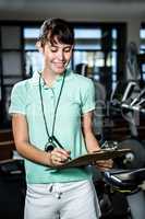 Smiling trainer holding clipboard