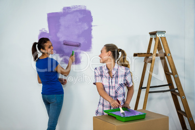 Friends painting a wall