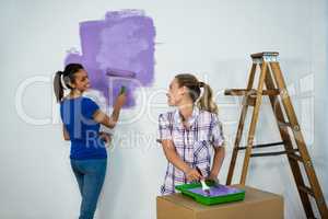 Friends painting a wall