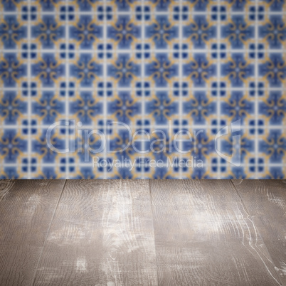 Wood table top and blur vintage ceramic tile pattern wall