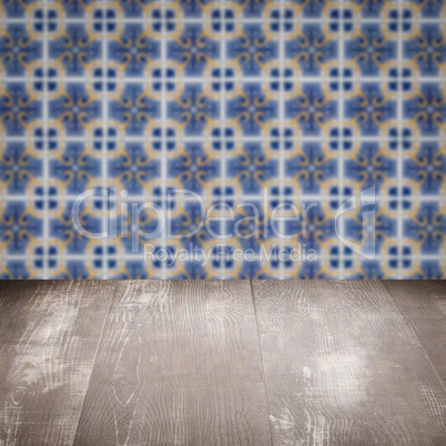 Wood table top and blur vintage ceramic tile pattern wall