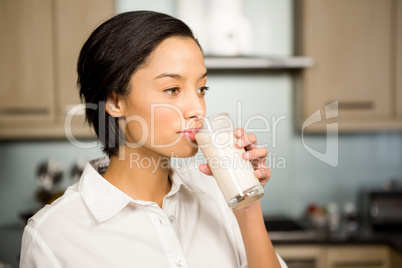 Smiling brunette drinking healthy smoothie