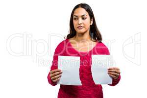 Woman holding torn documents