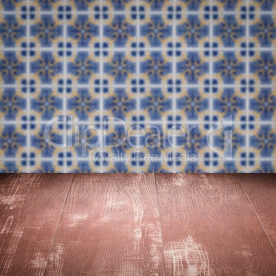 Wood table top and blur vintage ceramic tile pattern wall