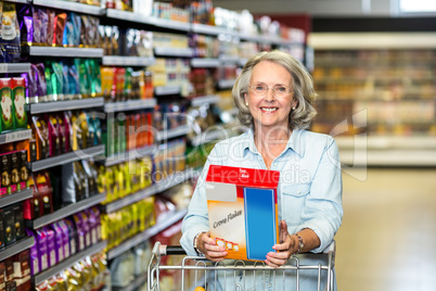 Smiling senior woman buying cereals