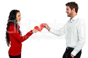 couple holding red cracked heart shape