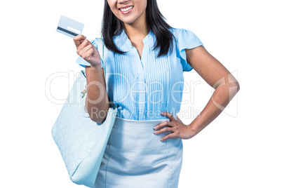 Smiling woman with a credit card in hand