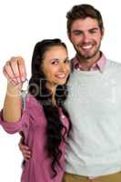Portrait of cheerful couple holding keys