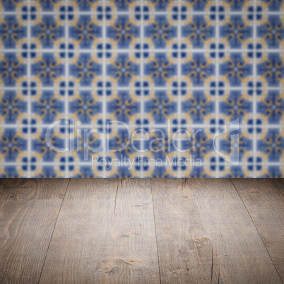 Wood table top and blur vintage ceramic tile pattern wall Wood table top and blur vintage ceramic tile pattern wall