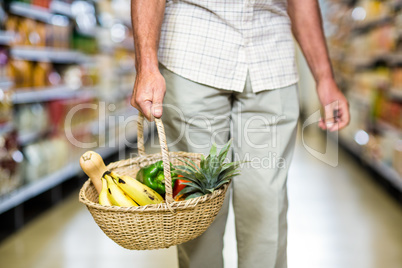 Cropped view of senior man holding basket