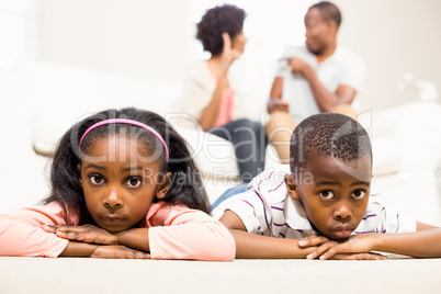 Unhappy kids sitting on the floor