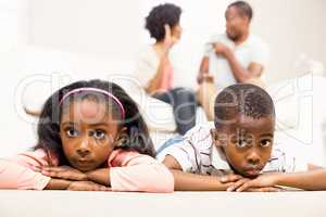 Unhappy kids sitting on the floor