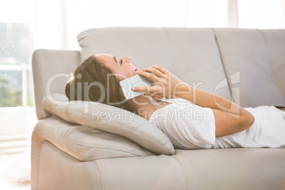 Happy woman calling on sofa