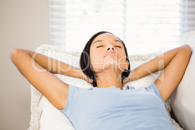 Relaxed brunette with hands behind head