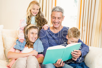 Happy parents reading to their kids