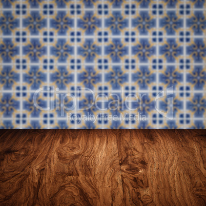 Wood table top and blur vintage ceramic tile pattern wall