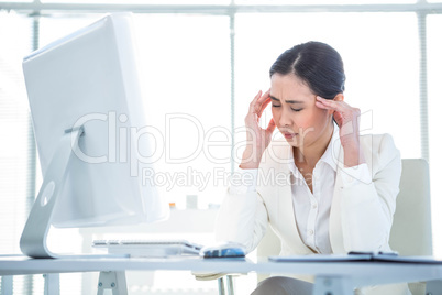 Stressed businesswoman working at her desk