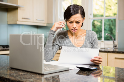 Worried brunette counting bills