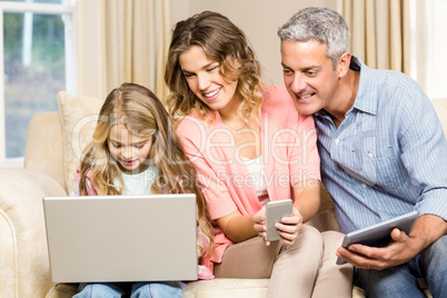 Happy family looking at laptop screen