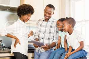 Happy family looking at tablet