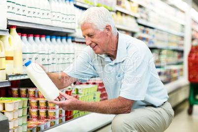 Senior man buying milk