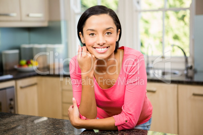 Portrait of smiling brunette in kitchen