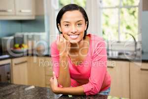Portrait of smiling brunette in kitchen