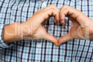 Cropped image of man making heart shape